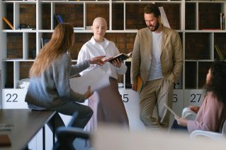 Colleagues discussing business issues in creative workspace